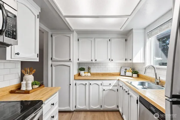 a kitchen with stainless steel appliances granite countertop a refrigerator sink and cabinets