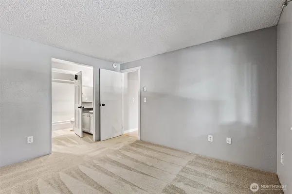 a en suite bathroom with a granite countertop sink and a mirror