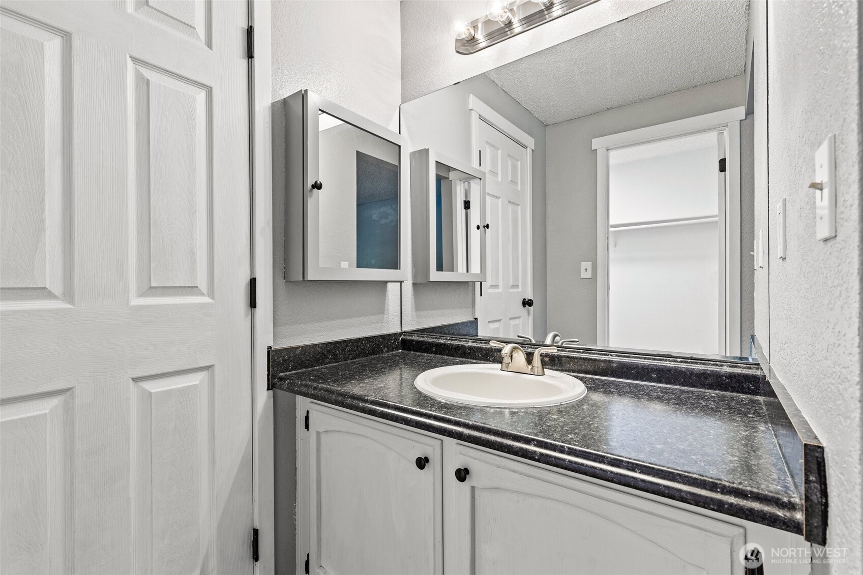 820 Cady Road, Unit H203 Everett, WA 98203 - Photo 17 of 30 a bathroom with a sink and a mirror