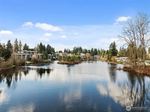 a view of residential houses with outdoor space and lake view