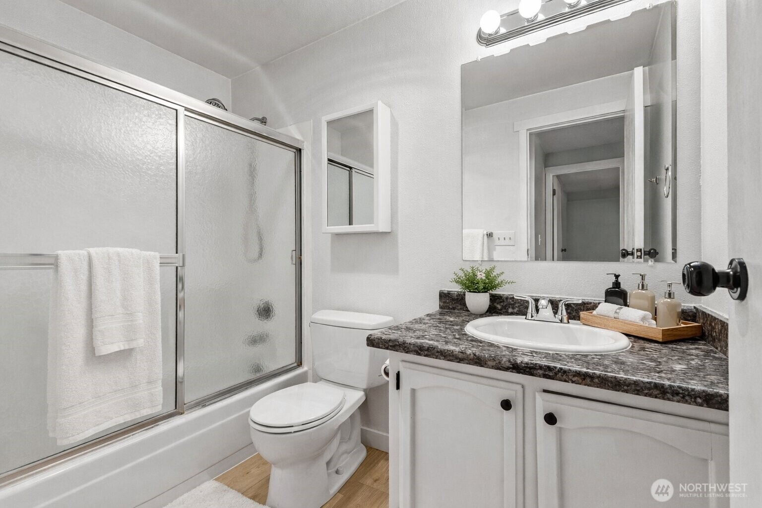 820 Cady Road, Unit H203 Everett, WA 98203 - Photo 21 of 30 a bathroom with a granite countertop toilet sink and shower