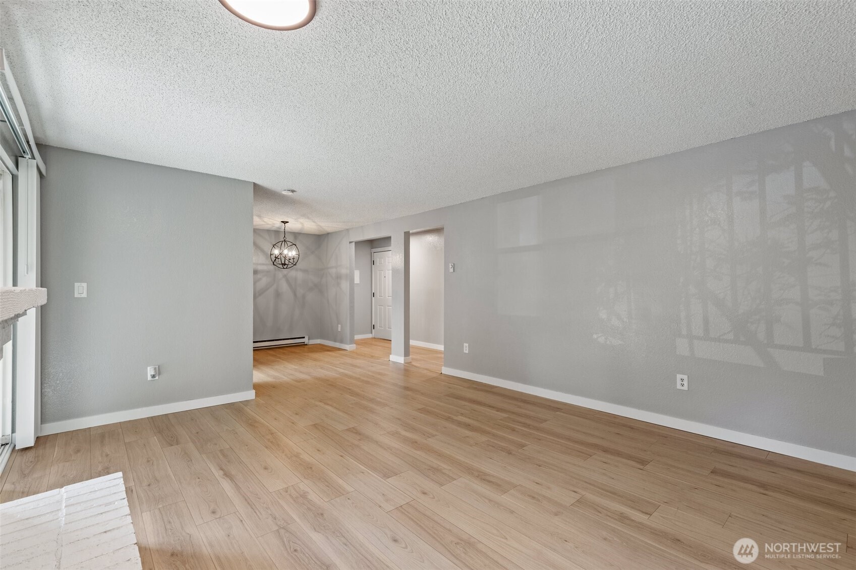 820 Cady Road, Unit H203 Everett, WA 98203 - Photo 7 of 30 a view of an empty room with wooden floor and a window