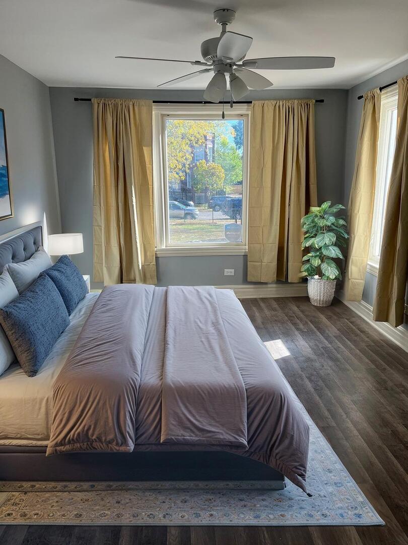 7438 South Champlain Avenue Chicago, IL 60619 - Photo 15 of 33 a bedroom with a bed and a large window