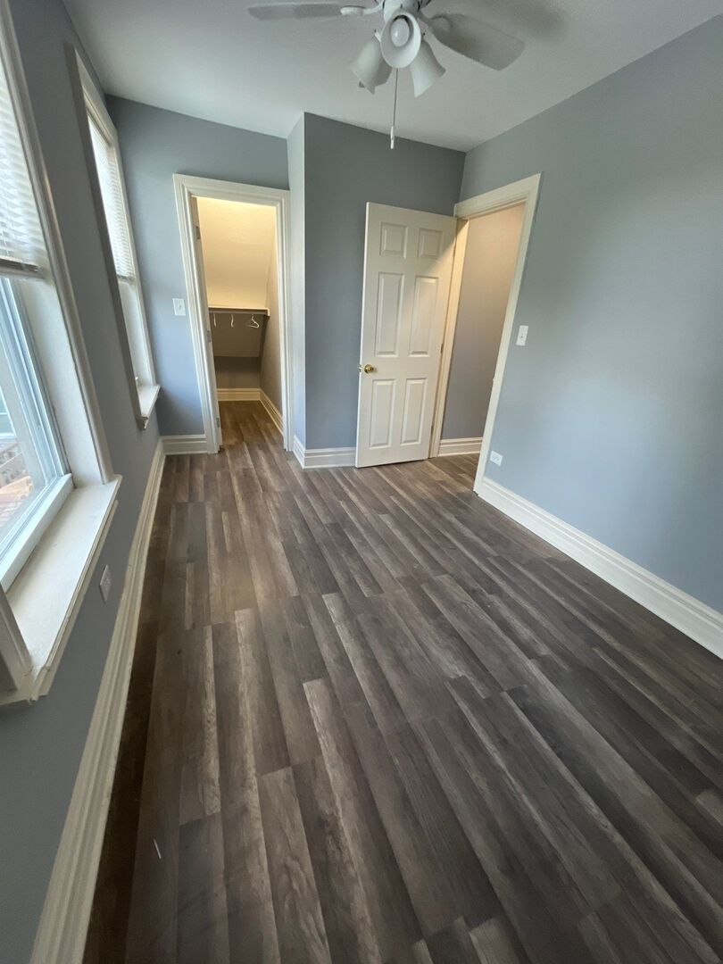 7438 South Champlain Avenue Chicago, IL 60619 - Photo 27 of 33 wooden floor in an empty room with a window