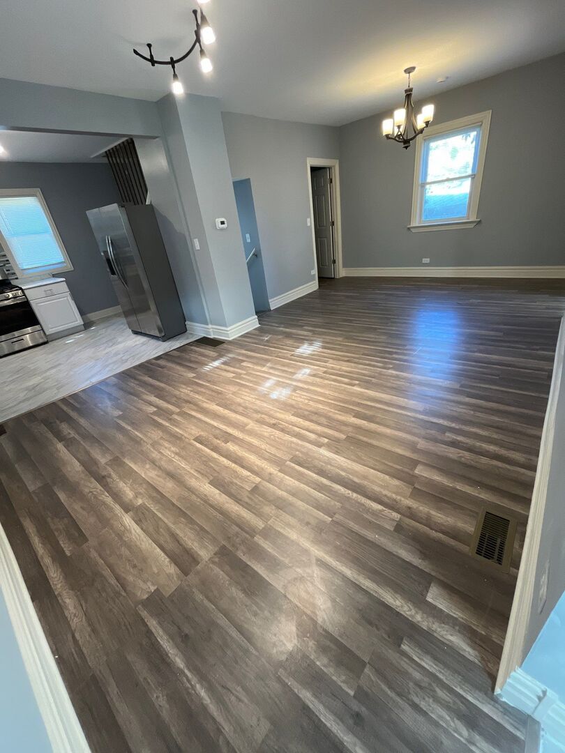 7438 South Champlain Avenue Chicago, IL 60619 - Photo 7 of 33 wooden floor in an empty room with a window