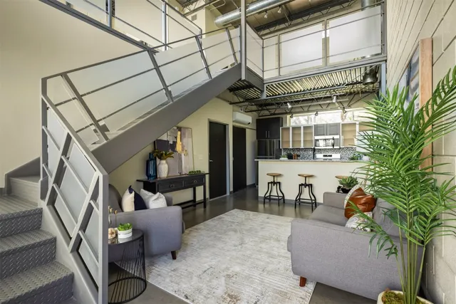 a living room with furniture and a potted plant