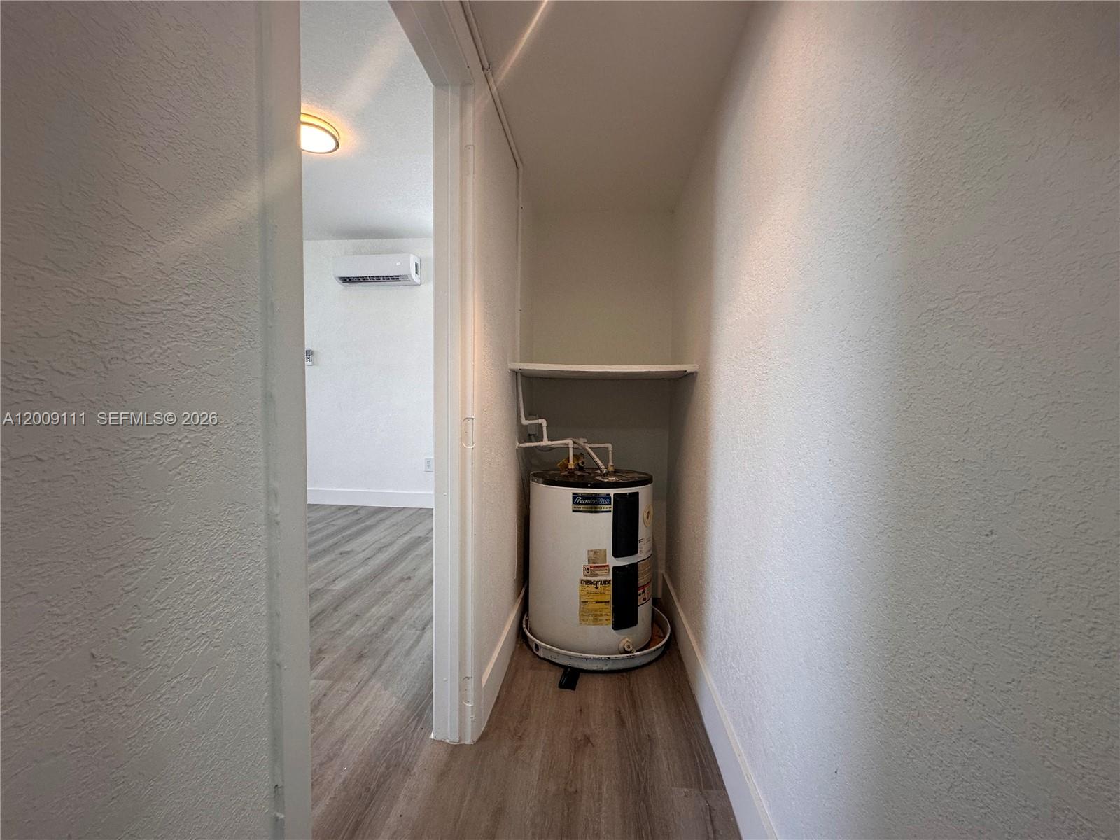 50 Northwest 79th Street, Unit 6 Miami, FL 33150 - Photo 16 of 30 a room with a fireplace and wooden floor