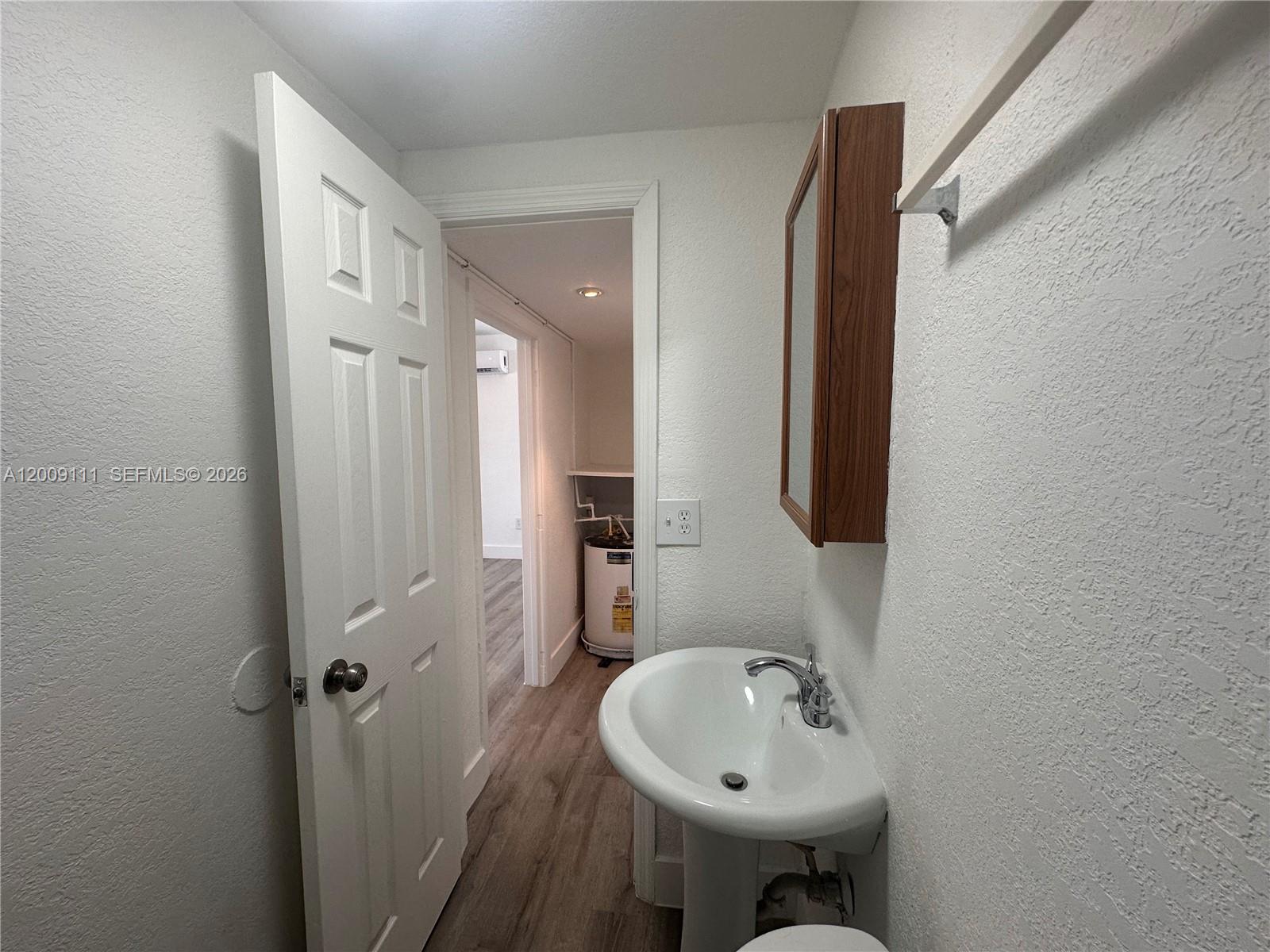 50 Northwest 79th Street, Unit 6 Miami, FL 33150 - Photo 18 of 30 a bathroom with a sink and a mirror