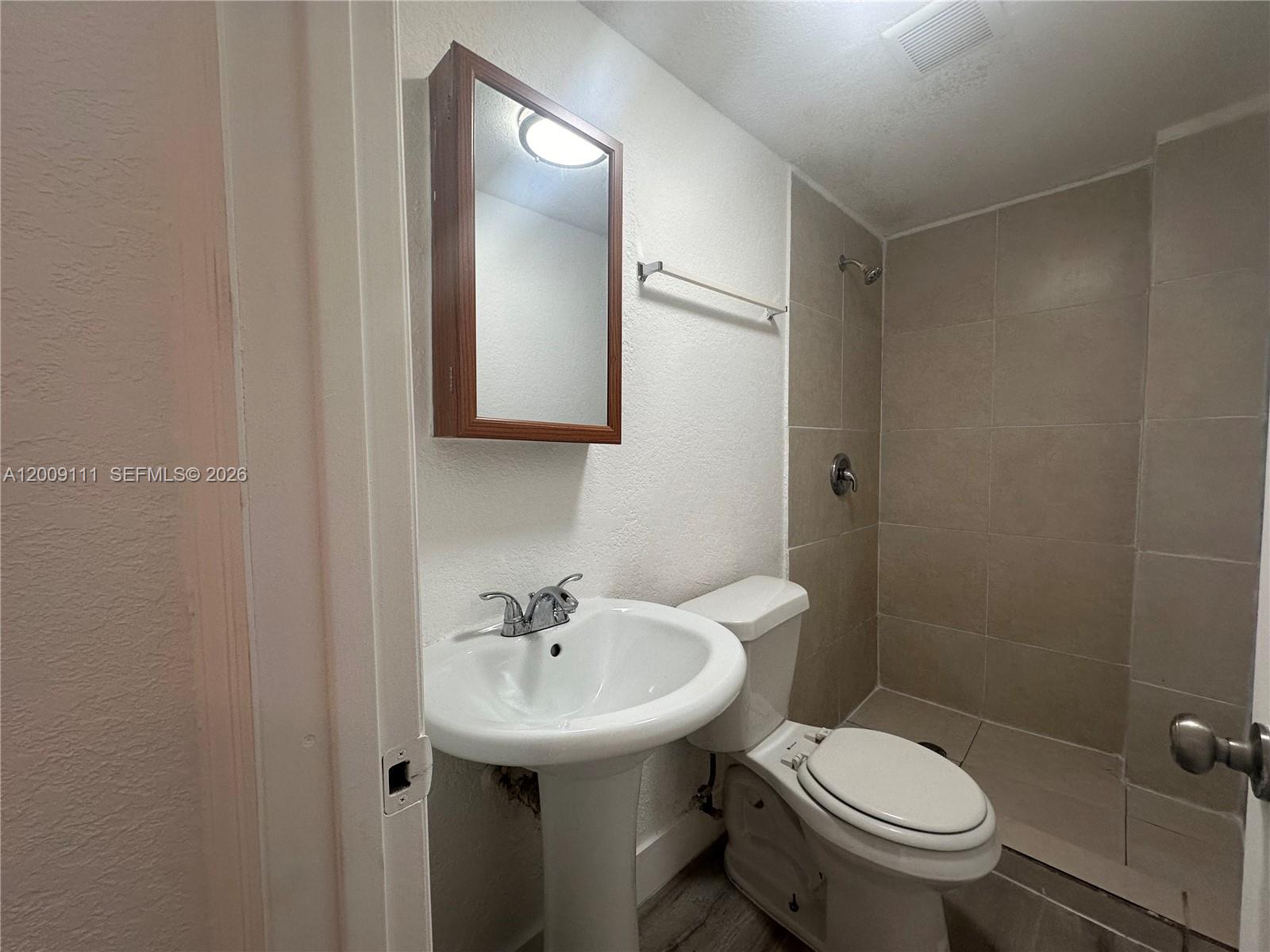 50 Northwest 79th Street, Unit 6 Miami, FL 33150 - Photo 19 of 30 a bathroom with a sink toilet and a mirror