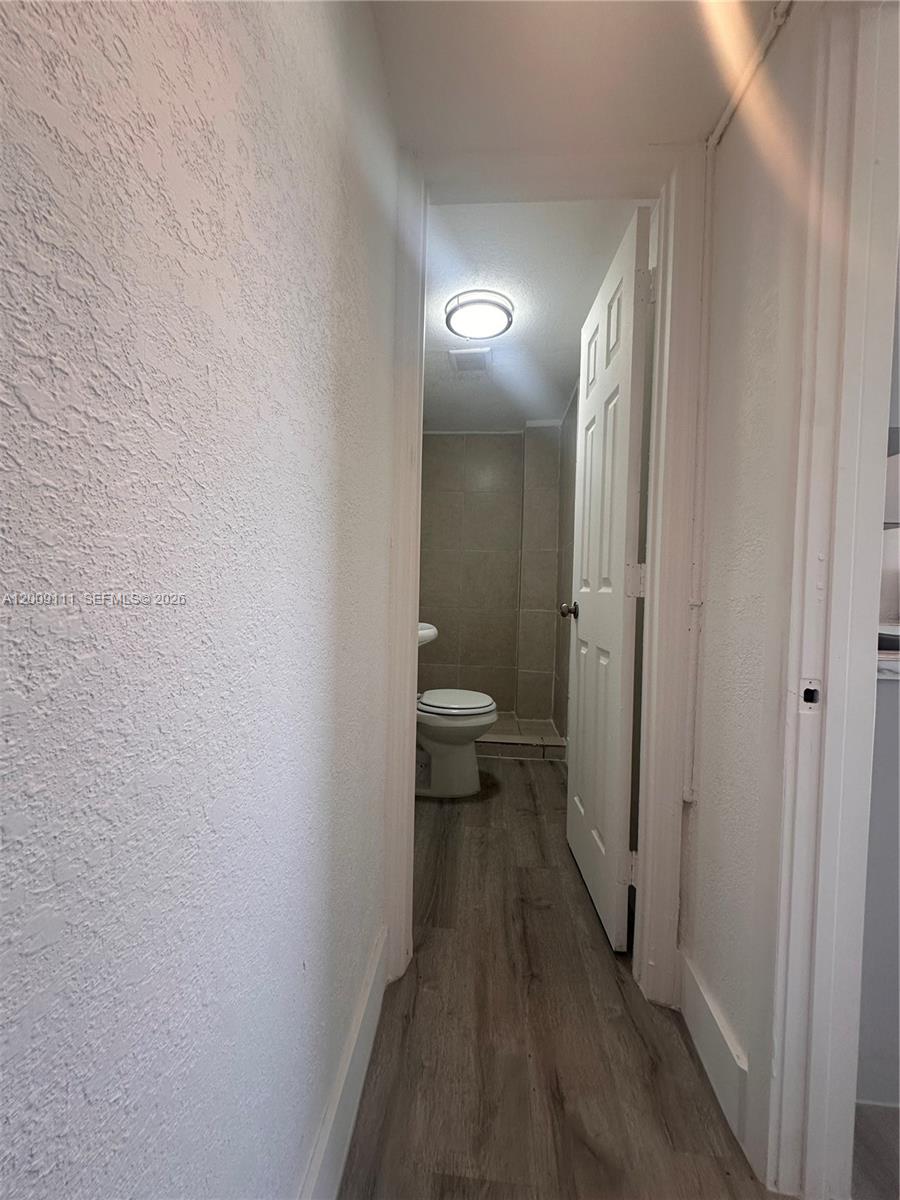 50 Northwest 79th Street, Unit 6 Miami, FL 33150 - Photo 2 of 30 a view of a bathroom from the hallway