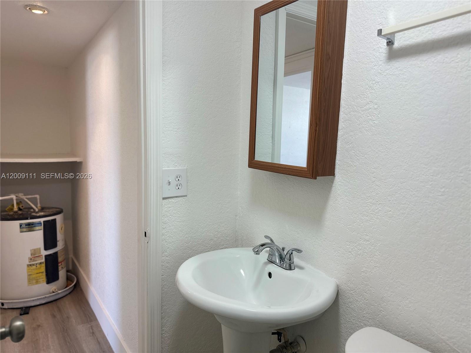 50 Northwest 79th Street, Unit 6 Miami, FL 33150 - Photo 21 of 30 a bathroom with a sink and a mirror