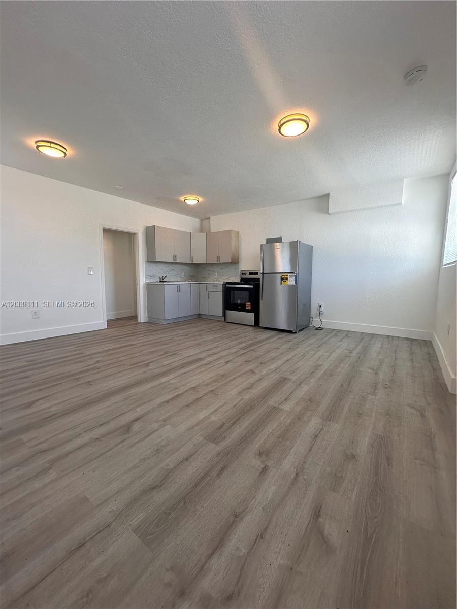 50 Northwest 79th Street, Unit 6 Miami, FL 33150 - Photo 3 of 30 a view of a kitchen with a sink and a window