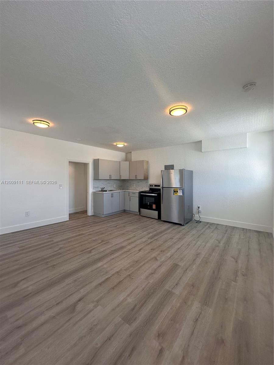50 Northwest 79th Street, Unit 6 Miami, FL 33150 - Photo 4 of 30 a view of empty room with kitchen and window