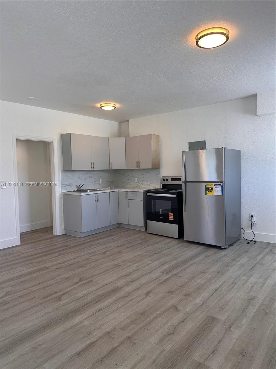 50 Northwest 79th Street, Unit 6 Miami, FL 33150 - Photo 5 of 30 a view of a kitchen with electric appliances and cabinets