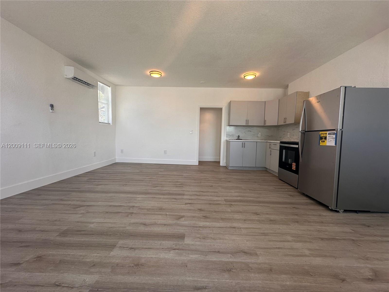 50 Northwest 79th Street, Unit 6 Miami, FL 33150 - Photo 7 of 30 a view of a kitchen with a refrigerator and a sink