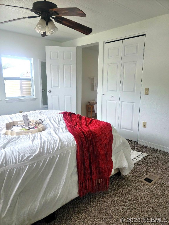 134 Douglas Street Edgewater, FL 32141 - Photo 12 of 27 a bed sitting in a bedroom next to a window and a chandelier