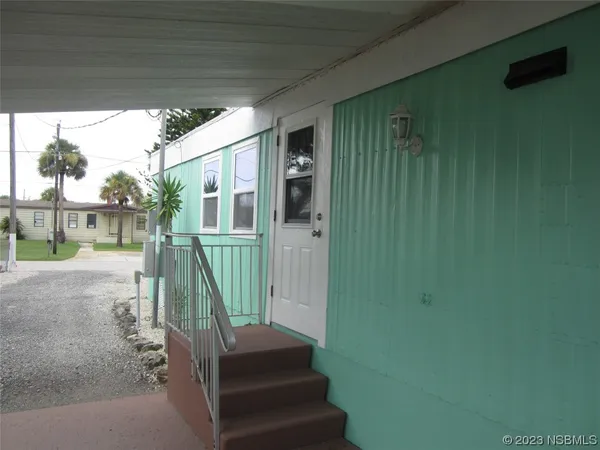 a view of a house with a small deck