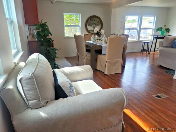 a living room with furniture and wooden floor