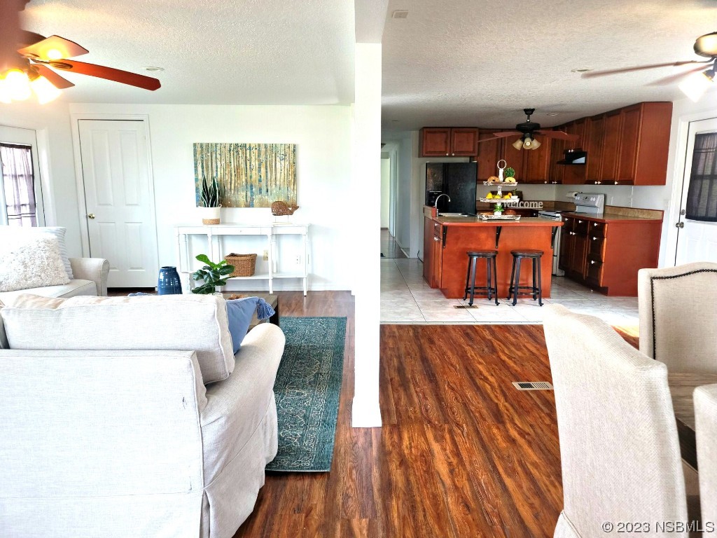 134 Douglas Street Edgewater, FL 32141 - Photo 7 of 27 a living room with furniture and kitchen view
