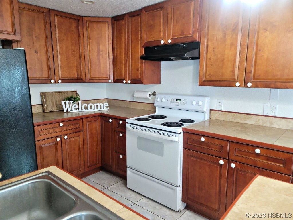 134 Douglas Street Edgewater, FL 32141 - Photo 8 of 27 a kitchen with stainless steel appliances granite countertop a sink stove and cabinets
