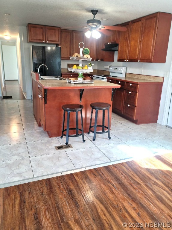 134 Douglas Street Edgewater, FL 32141 - Photo 9 of 27 a kitchen with stainless steel appliances granite countertop a sink and a refrigerator