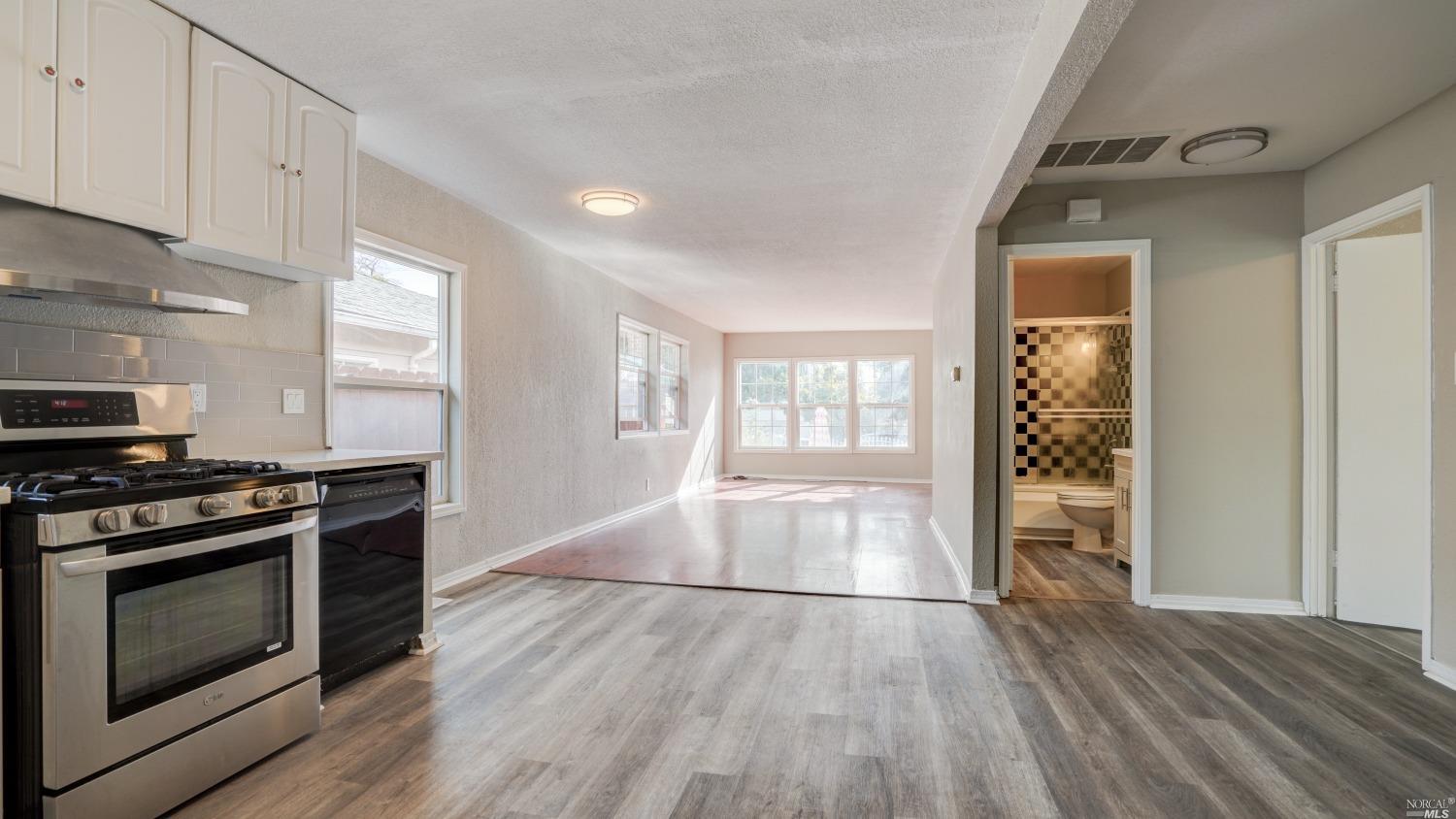 a kitchen with granite countertop wooden floors and stainless steel appliances