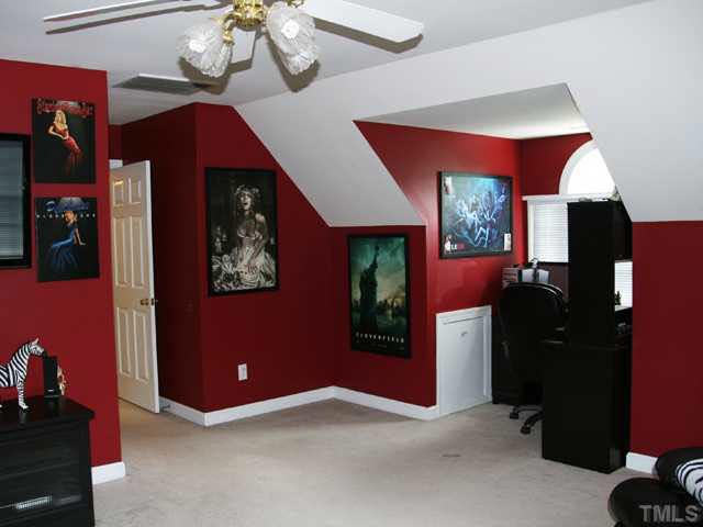 2405 Trellis Court Raleigh, NC 27616 - Photo 12 of 23 Upstairs, the bonus room over the garage is a fun and dramatic space! It features crawl-space storage, a closet and an office nook by the palladian window.