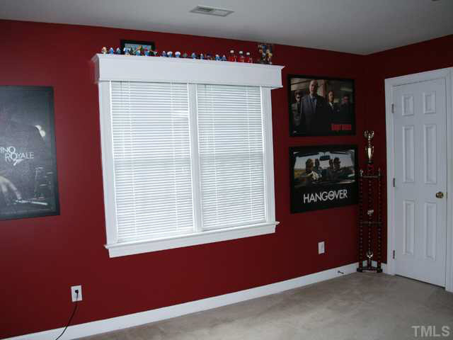 2405 Trellis Court Raleigh, NC 27616 - Photo 13 of 23 Lots of natural light and a full closet suggest that the bonus room could be a potential fourth bedroom.
