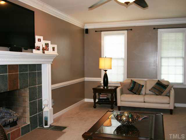 2405 Trellis Court Raleigh, NC 27616 - Photo 9 of 23 The large, warm, comfortable living room fills the house from front to back. New carpeting, new tile on the fireplace hearth, and a handsome traditional mantle provide simple elegance and a welcoming ambience.