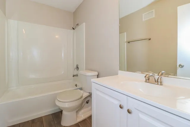 a bathroom with a sink a toilet and a bathtub