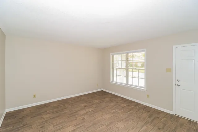 wooden floor in an empty room with a window