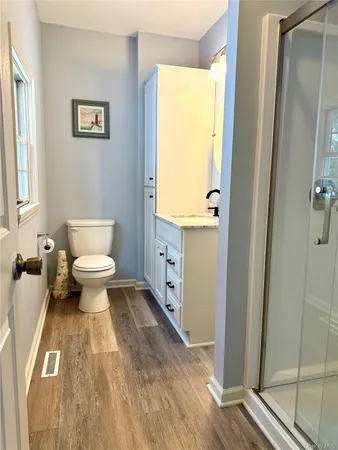 a bathroom with a toilet sink and a mirror