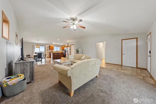 a living room with furniture and a chandelier