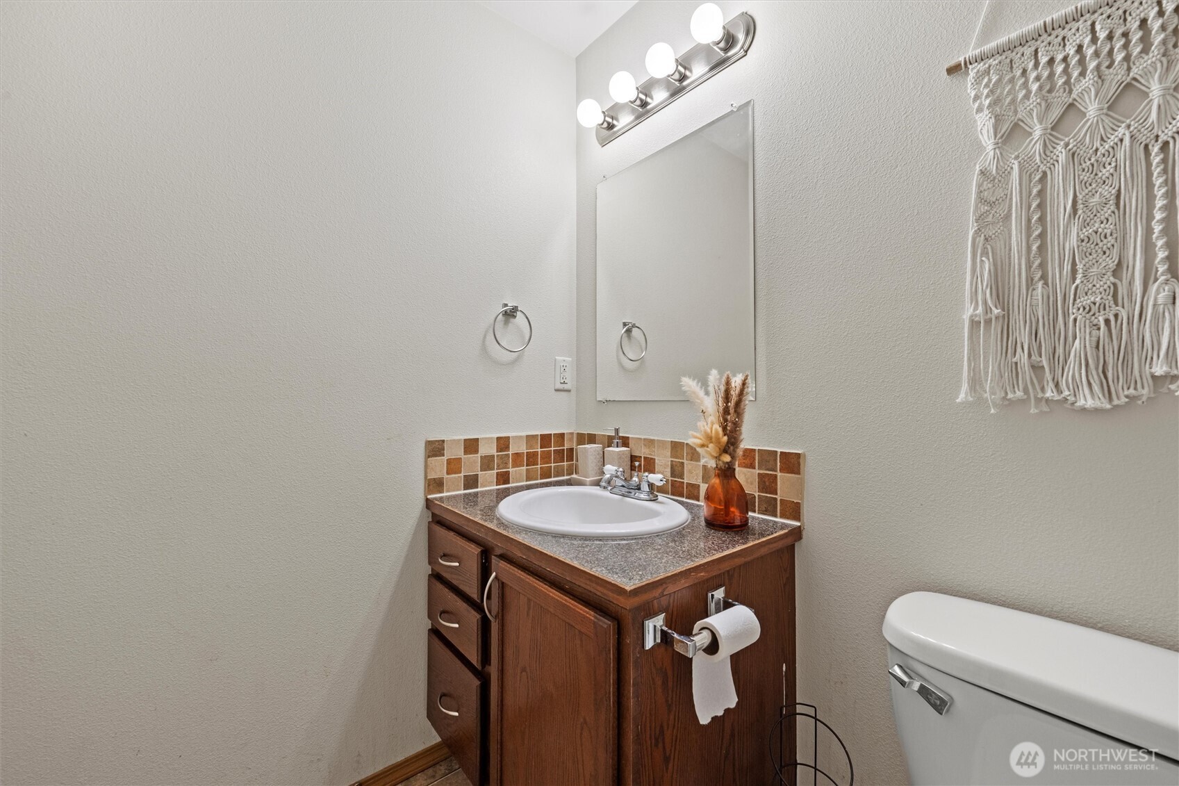 682 L Street Southeast Ephrata, WA 98823 - Photo 24 of 40 a bathroom with a granite countertop sink vanity mirror and toilet