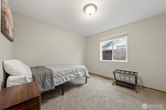 a living room with a bed furniture and a window