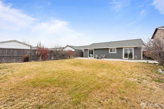 a house view with swimming pool in front of it