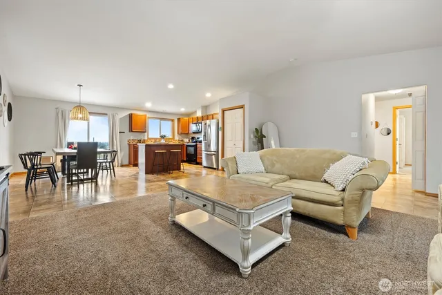 a living room with furniture and kitchen view