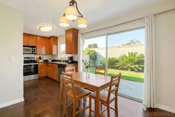 a kitchen with a table chairs stove and refrigerator
