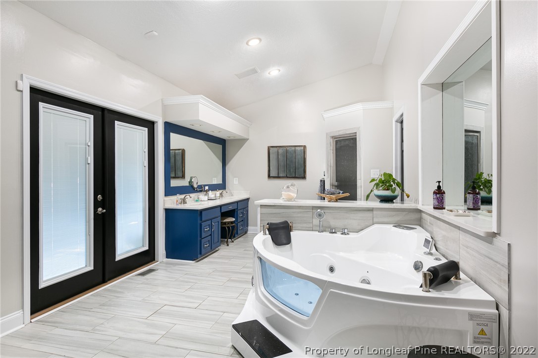 5016 J T Matthews Road Godwin, NC 28344 - Photo 12 of 50 a bathroom with a tub sink and mirror