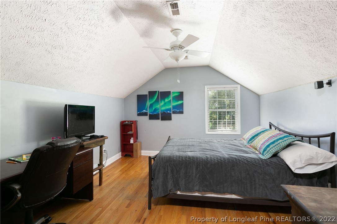 5016 J T Matthews Road Godwin, NC 28344 - Photo 20 of 50 a bedroom with a bed and wooden floor
