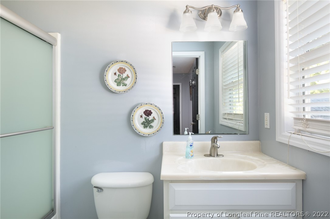 5016 J T Matthews Road Godwin, NC 28344 - Photo 24 of 50 a bathroom with a toilet and a sink