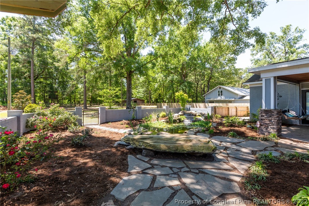 5016 J T Matthews Road Godwin, NC 28344 - Photo 31 of 50 a view of a patio with table and chairs under an umbrella