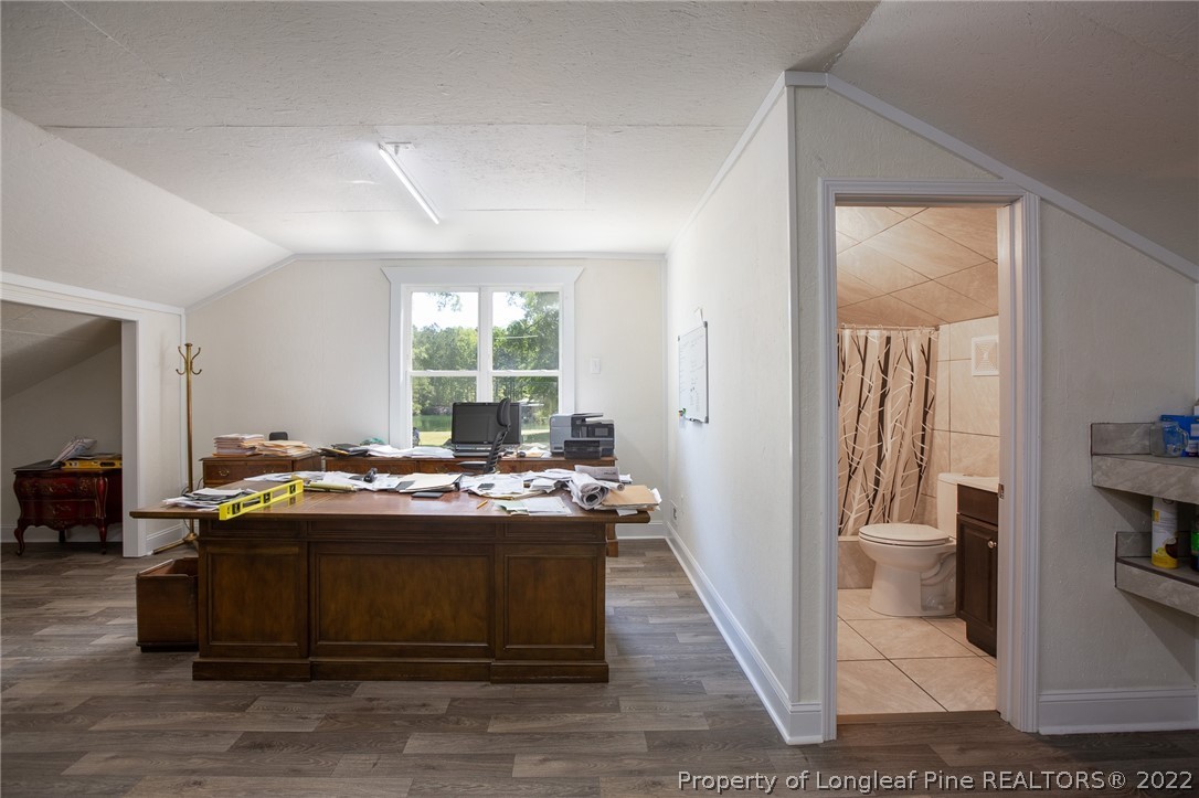 5016 J T Matthews Road Godwin, NC 28344 - Photo 42 of 50 a room with a bed and a table in it