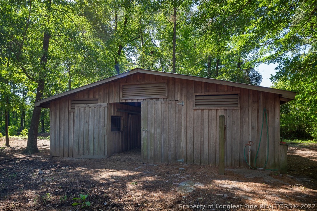 5016 J T Matthews Road Godwin, NC 28344 - Photo 45 of 50 a backyard of a house with large trees and wooden fence
