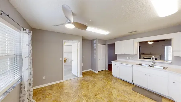 a large white kitchen with a sink
