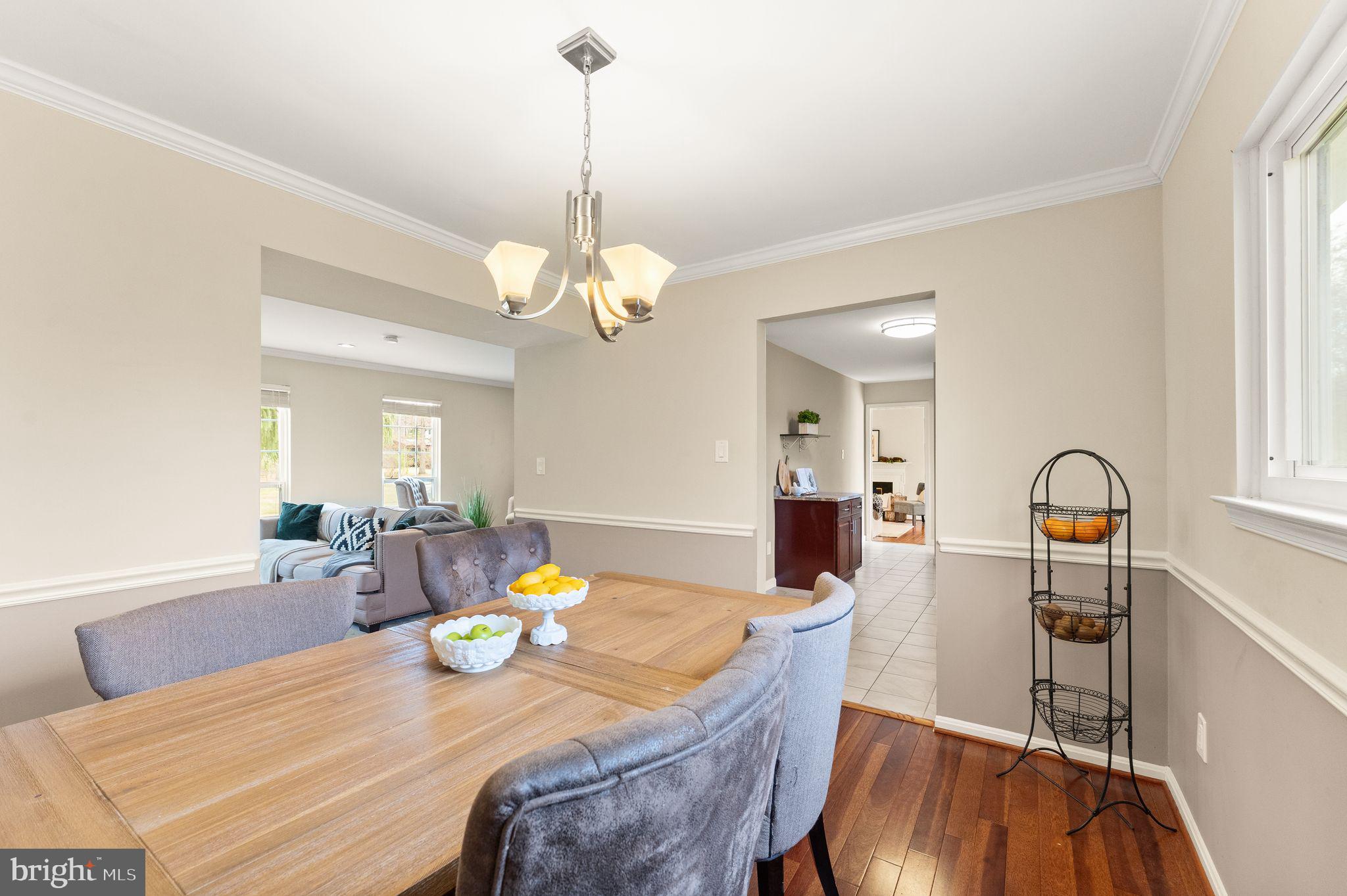 2412 Ivywood Road Reston, VA 20191 - Photo 15 of 63 a view of a dining room and livingroom with furniture wooden floor a chandelier