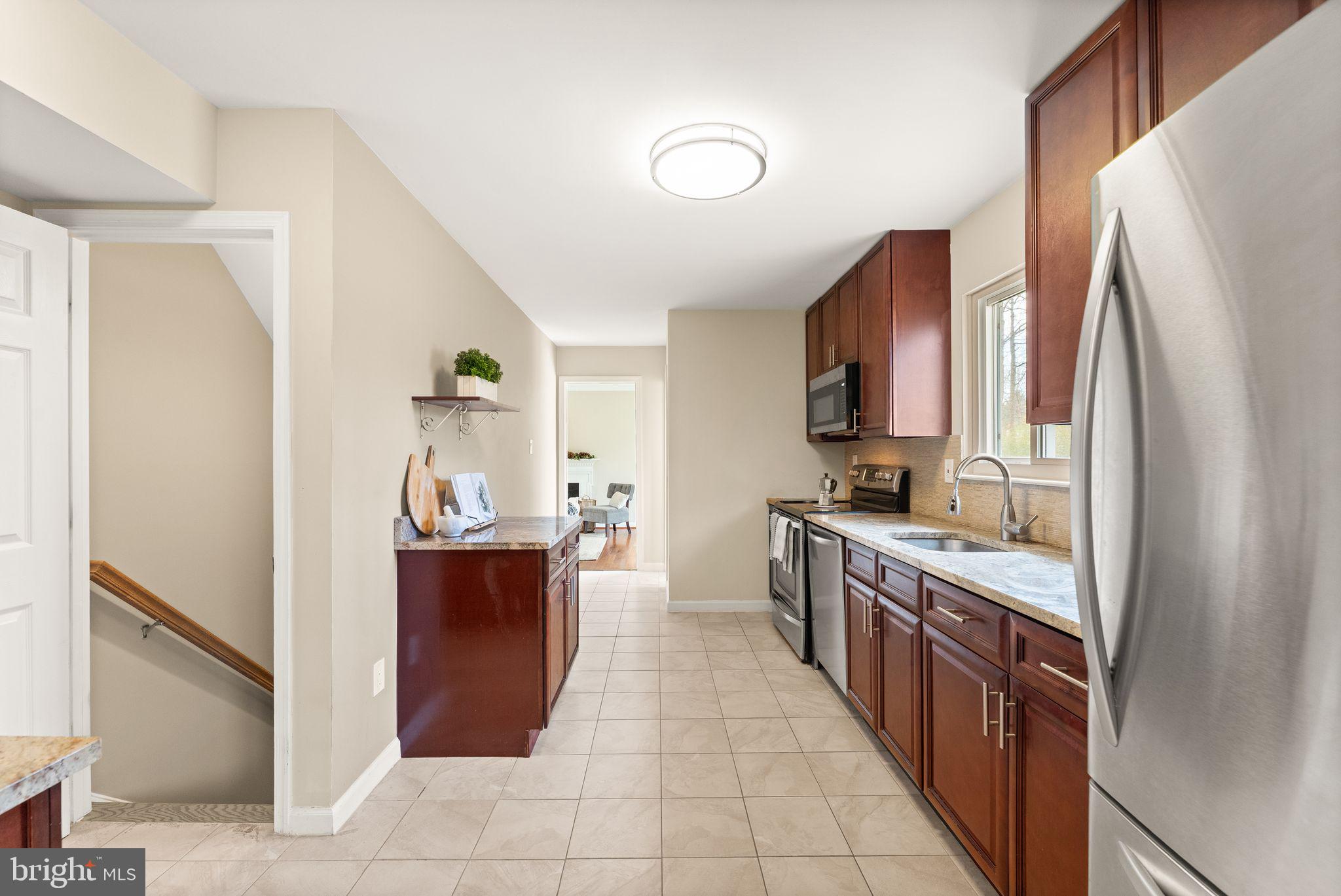 2412 Ivywood Road Reston, VA 20191 - Photo 16 of 63 a large kitchen with stainless steel appliances granite countertop a refrigerator and a stove