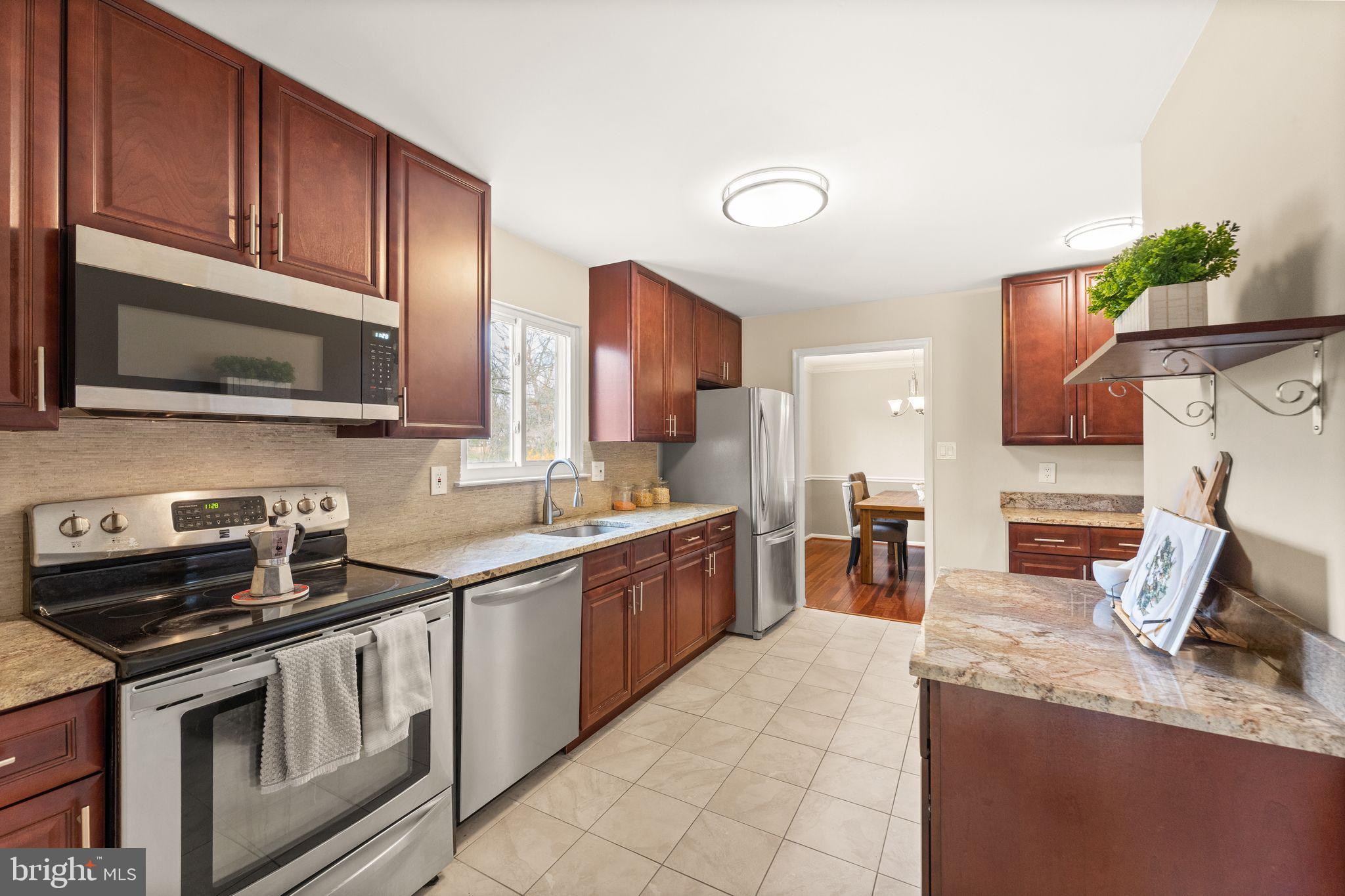 2412 Ivywood Road Reston, VA 20191 - Photo 19 of 63 a kitchen with stainless steel appliances granite countertop a sink stove and microwave