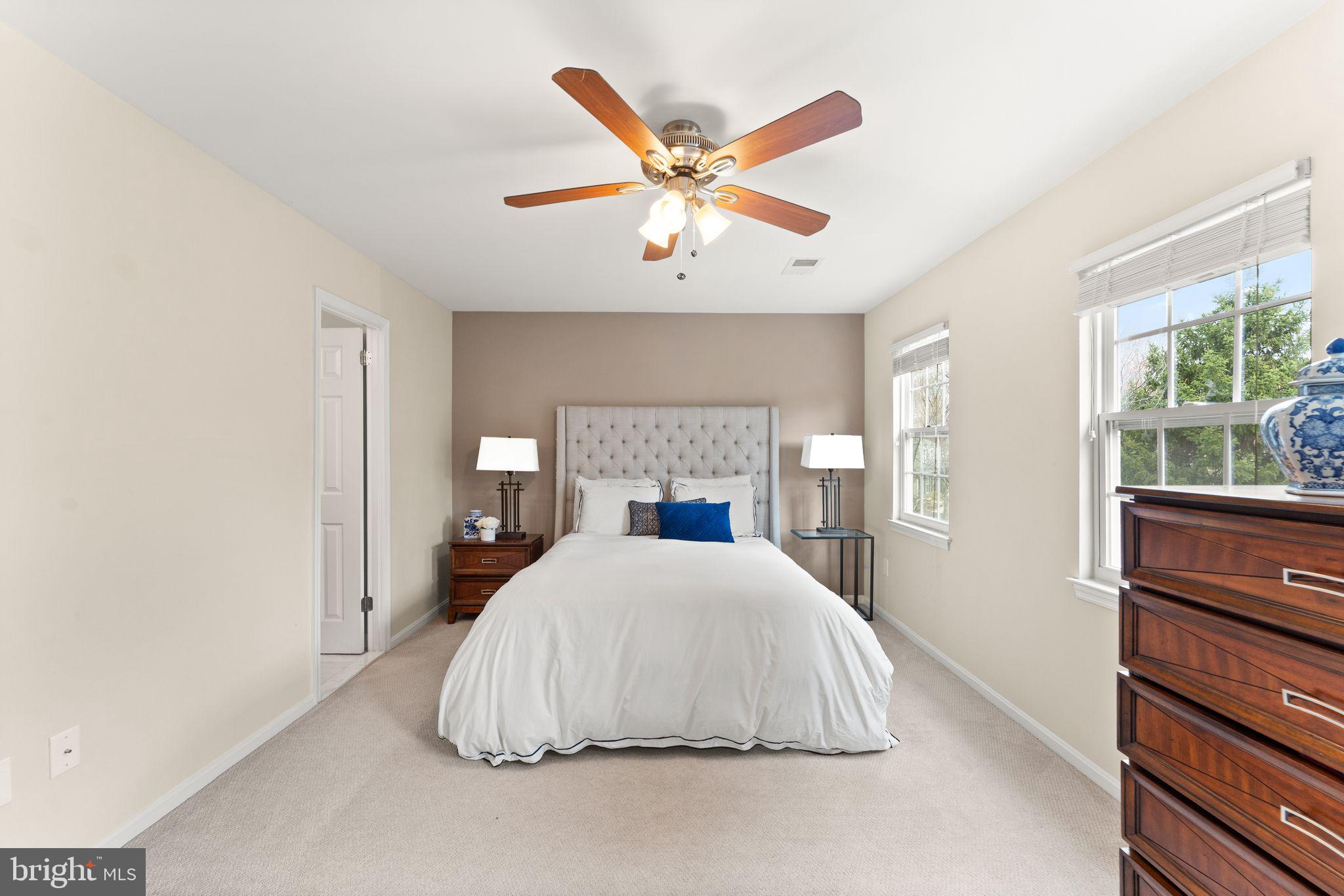 2412 Ivywood Road Reston, VA 20191 - Photo 27 of 63 a bedroom with a large bed and a chandelier
