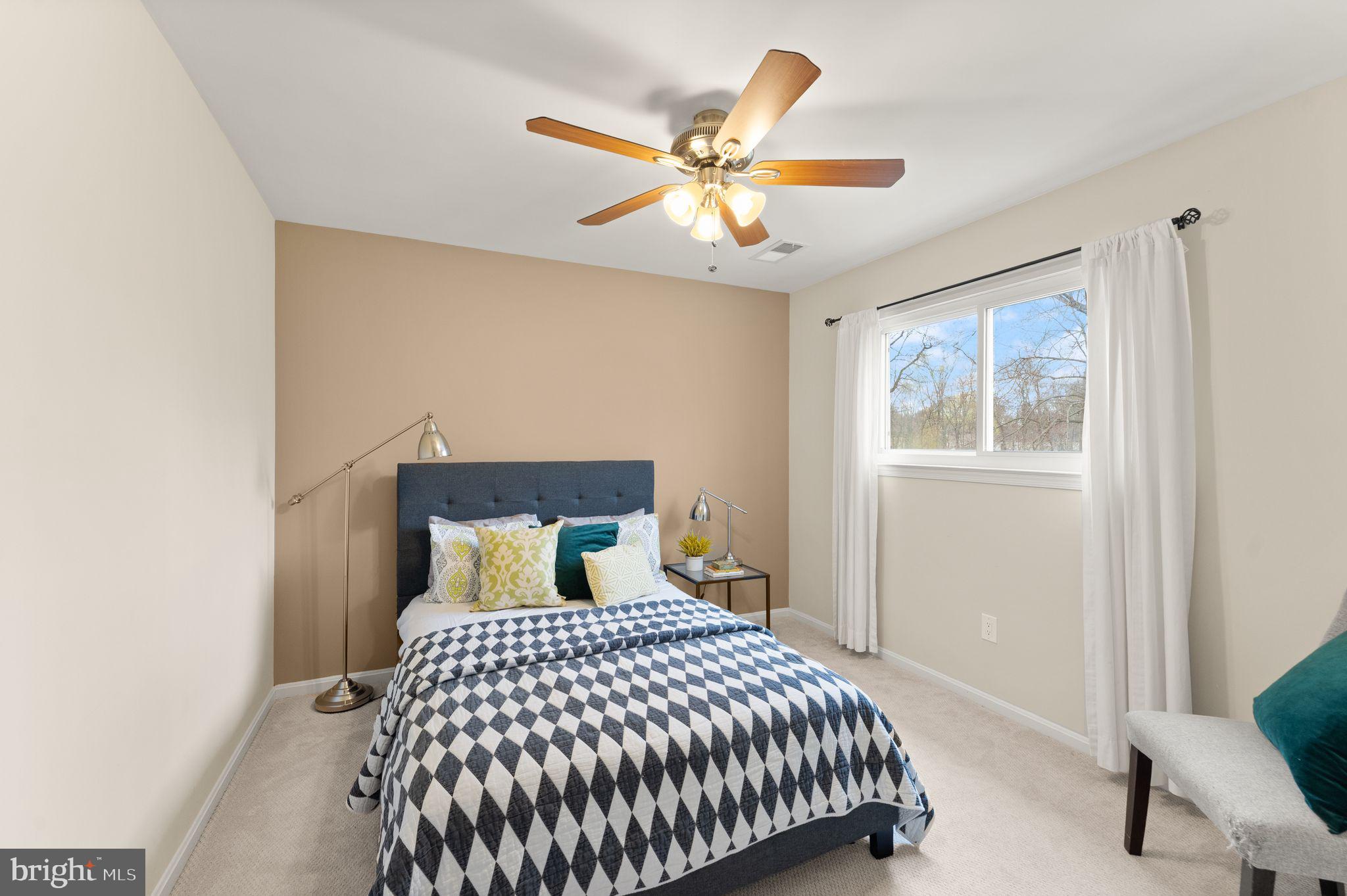 2412 Ivywood Road Reston, VA 20191 - Photo 36 of 63 a bedroom with a large bed and a chandelier